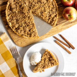 overhead shot of apple crumble tart recipe in pan and slice on a plate