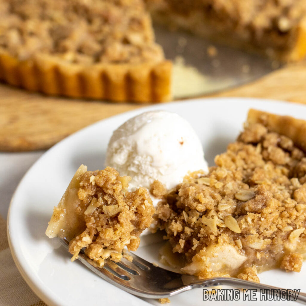 apple crumble tart recipe served on a bite with a bite on a fork