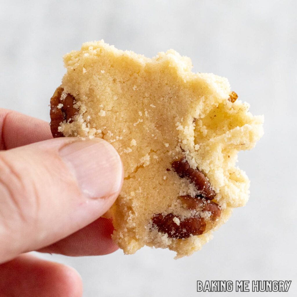 hand holding a piece of pecan cookie brittle