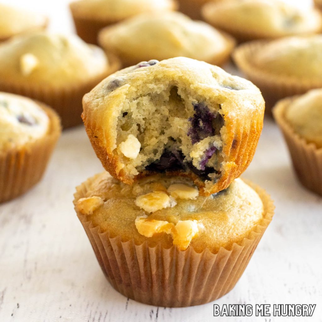 blueberry white chocolate muffins missing a bite stacked