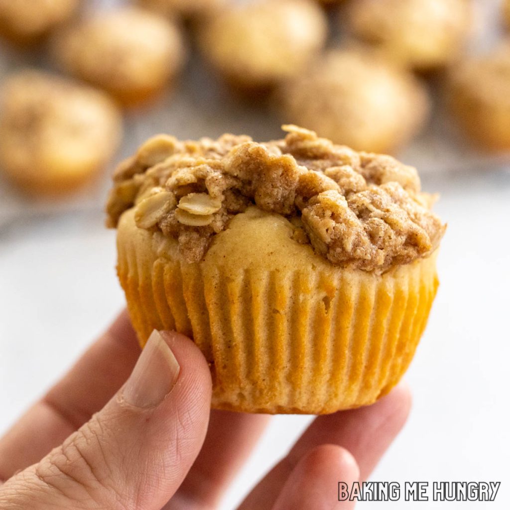 hand lifting up a muffin from the cinnamon streusel muffins recipe