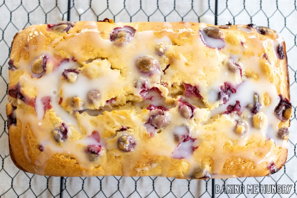 glaze topped cranberry cream cheese bread on wire rack