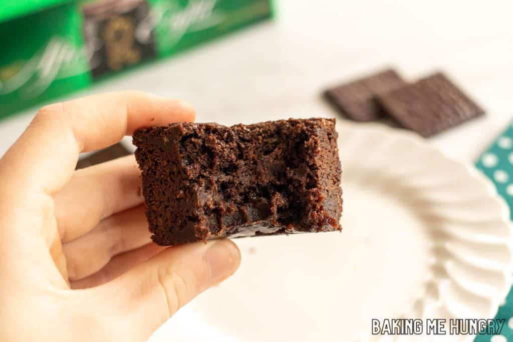 hand holding one of the after eight brownies with a bite missing
