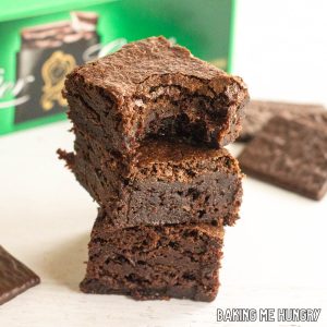after eight brownies in a stack in front of box