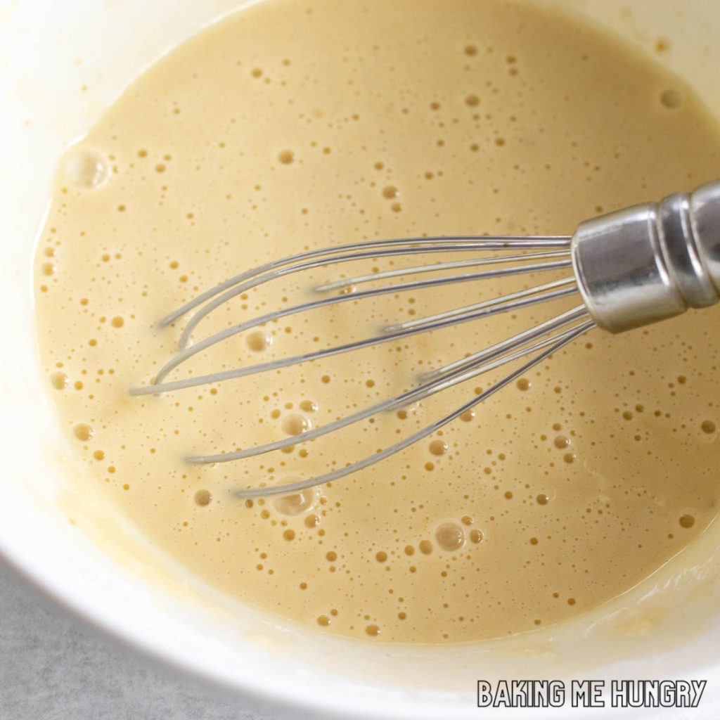 custard in bowl with whisk