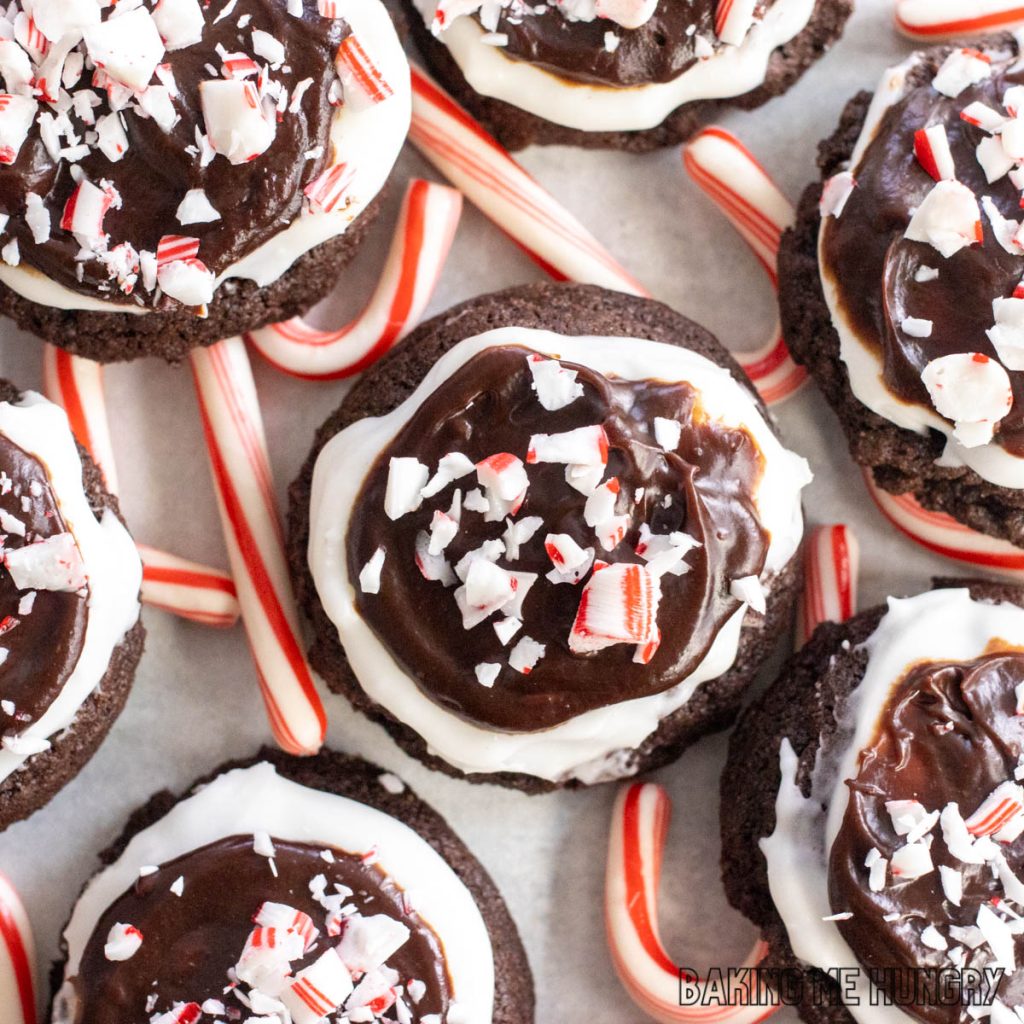 candy cane brownie cookies resting on top of candy canes

