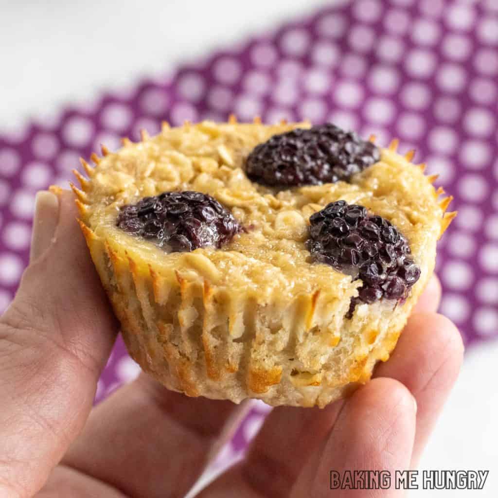 hand holding up one of the banana blackberry oatmeal muffins