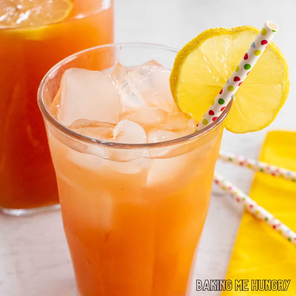 iced guava white tea lemonade recipe served in a glass with a straw and slice of lemon