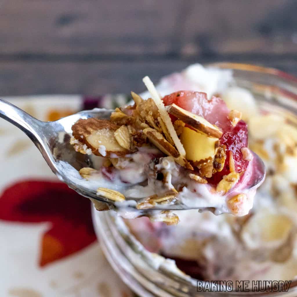 vanilla almond granola recipe with yogurt and strawberries on spoon