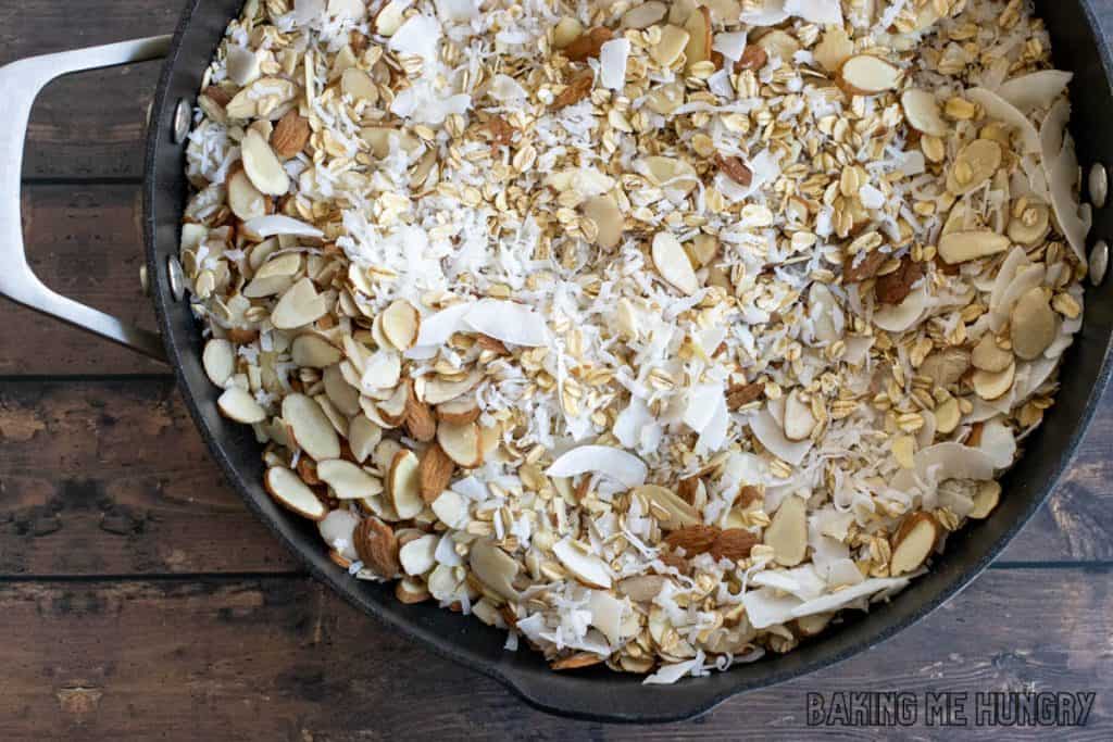 oats, nuts, and coconut in skillet
