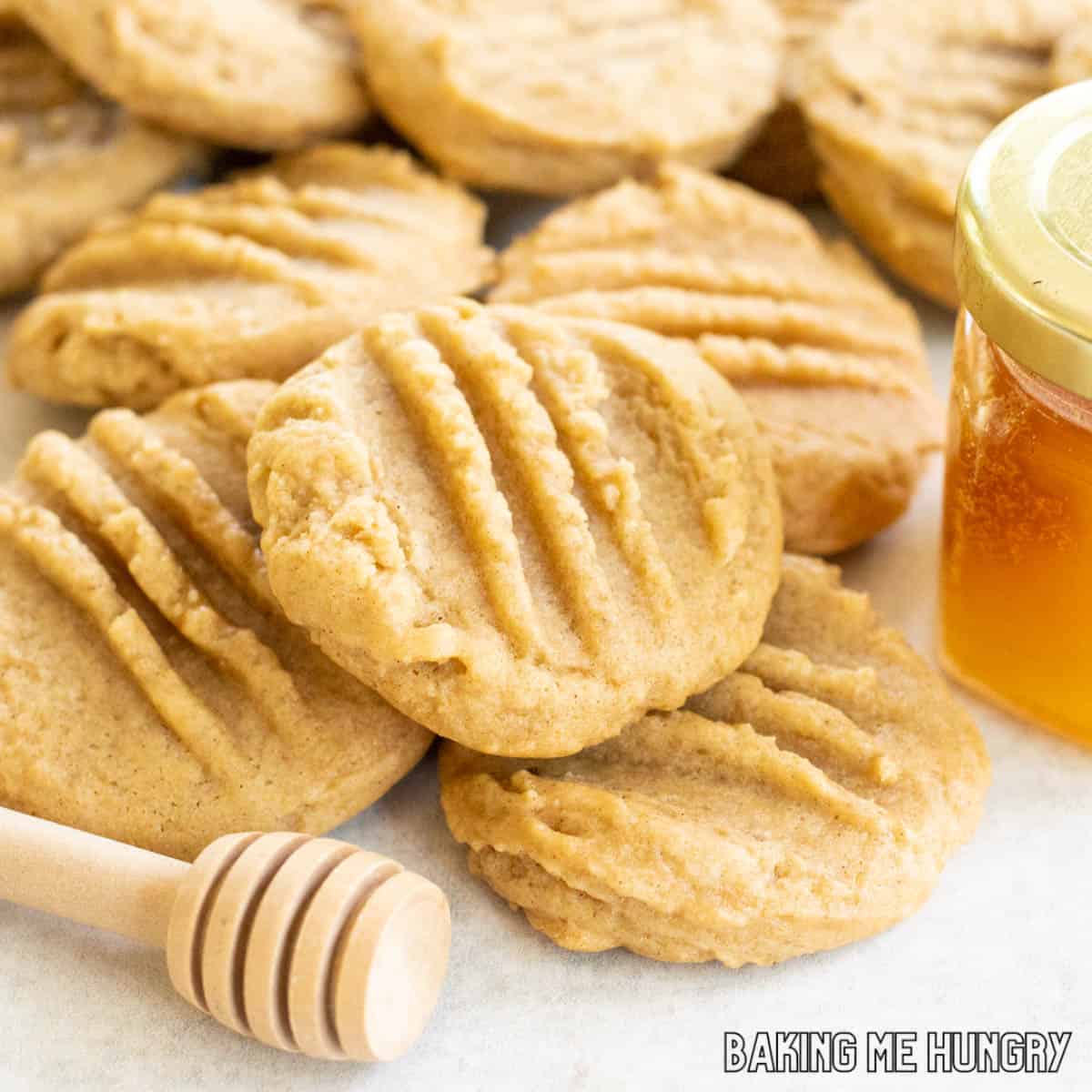 honey cookies recipe in a pile next to tiny jar of honey