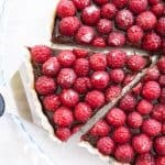 chocolate raspberry tart slice with pie server under it