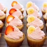 strawberry banana cupcakes topped with slices of fruit
