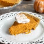 no bake pumpkin pie with graham cracker crust on decorative white plate