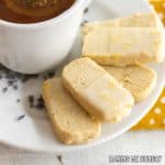 lavender lemon shortbread cookies on a small plate with a cup of tea