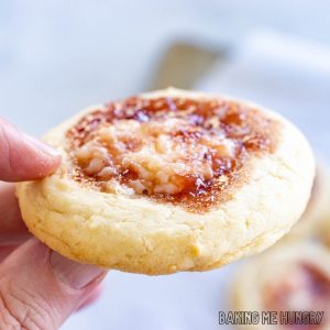 one of the strawberry cheesecake cookies being held up by a woman's hand
