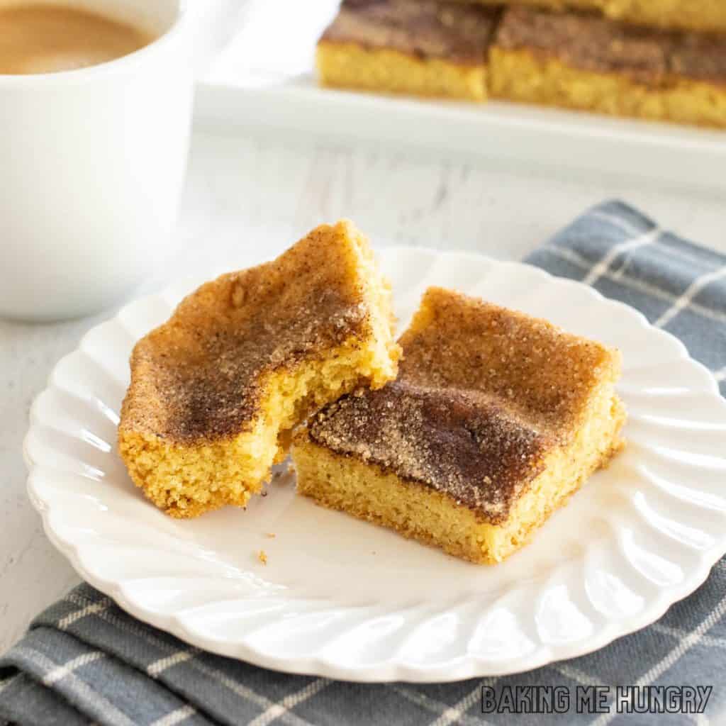 snickerdoodle cookie bars on small plate close up with one missing a bite