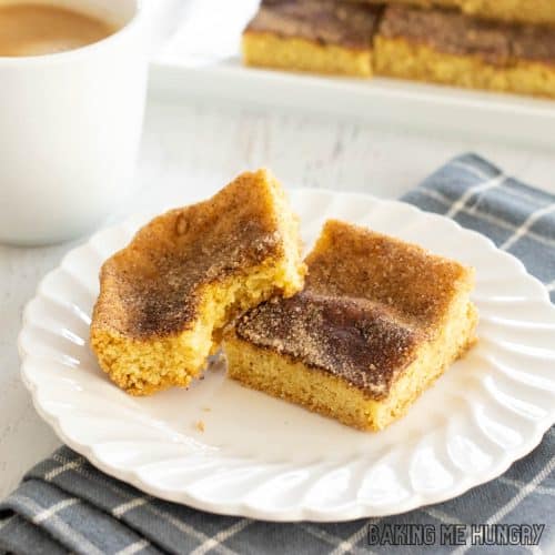 snickerdoodle cookie bars on small plate close up with one missing a bite