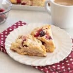 white chocolate cranberry scones on small plate close up