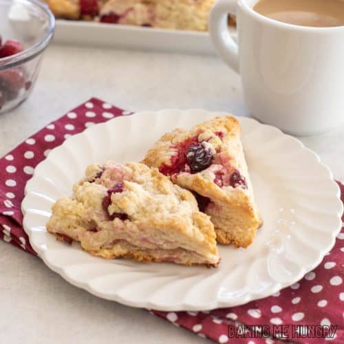 white chocolate cranberry scones on small plate close up