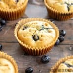dairy free blueberry muffins shown close up on wood surface