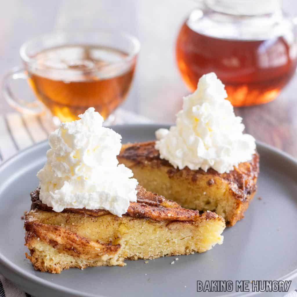 apple tea cake recipe sliced and served on plate with whipped cream