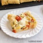 caprese focaccia recipe piece on small plate close up