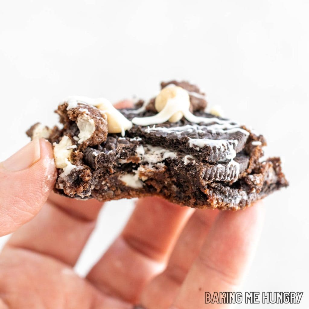 hand holding one of the cookies and cream cookie bars missing a bite
