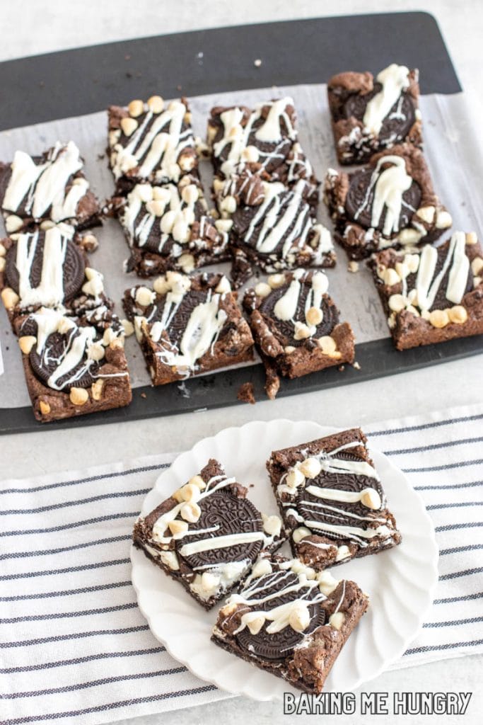 cookies and cream cookie bars on small plate with remaining bars on cutting board