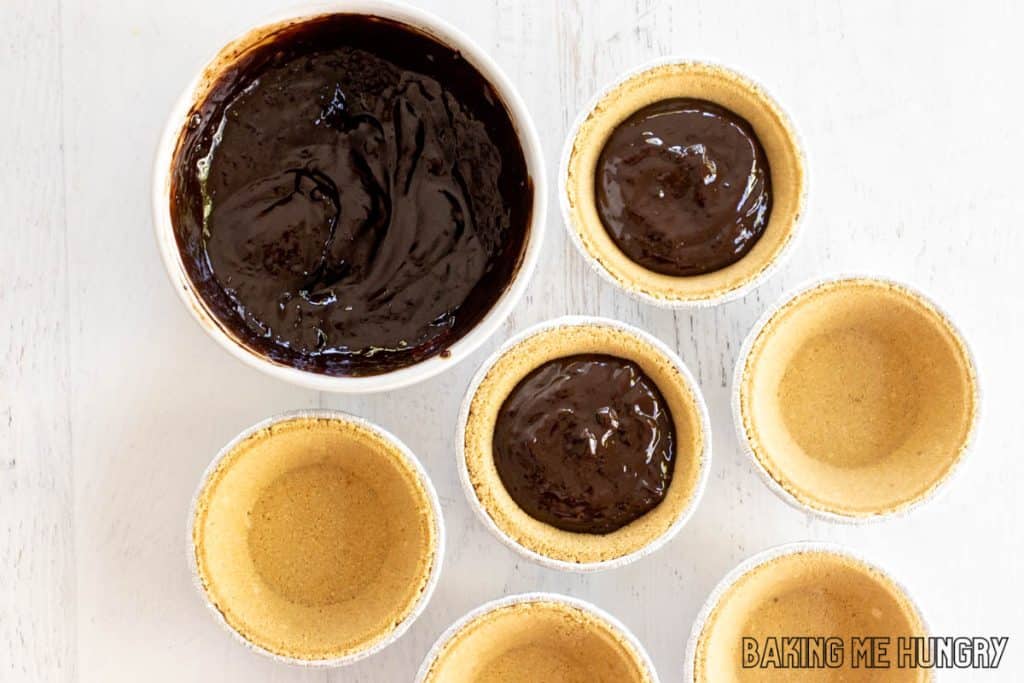 ganache in bowl being added to crusts