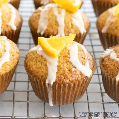 orange poppy seed muffins close up on wire rack
