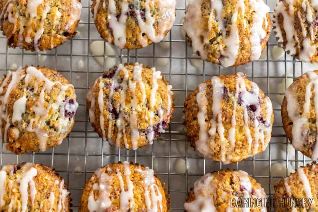 raspberry white chocolate muffins on wire rack being glazed