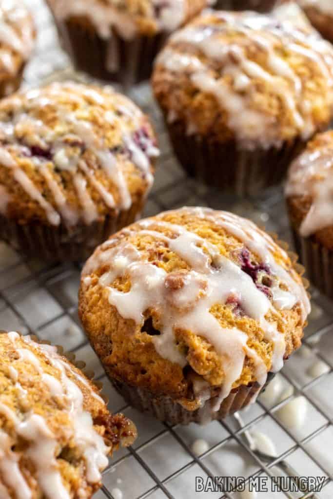 raspberry white chocolate muffins on wire rack being glazed