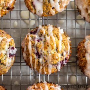 raspberry white chocolate muffins on wire rack being glazed close up