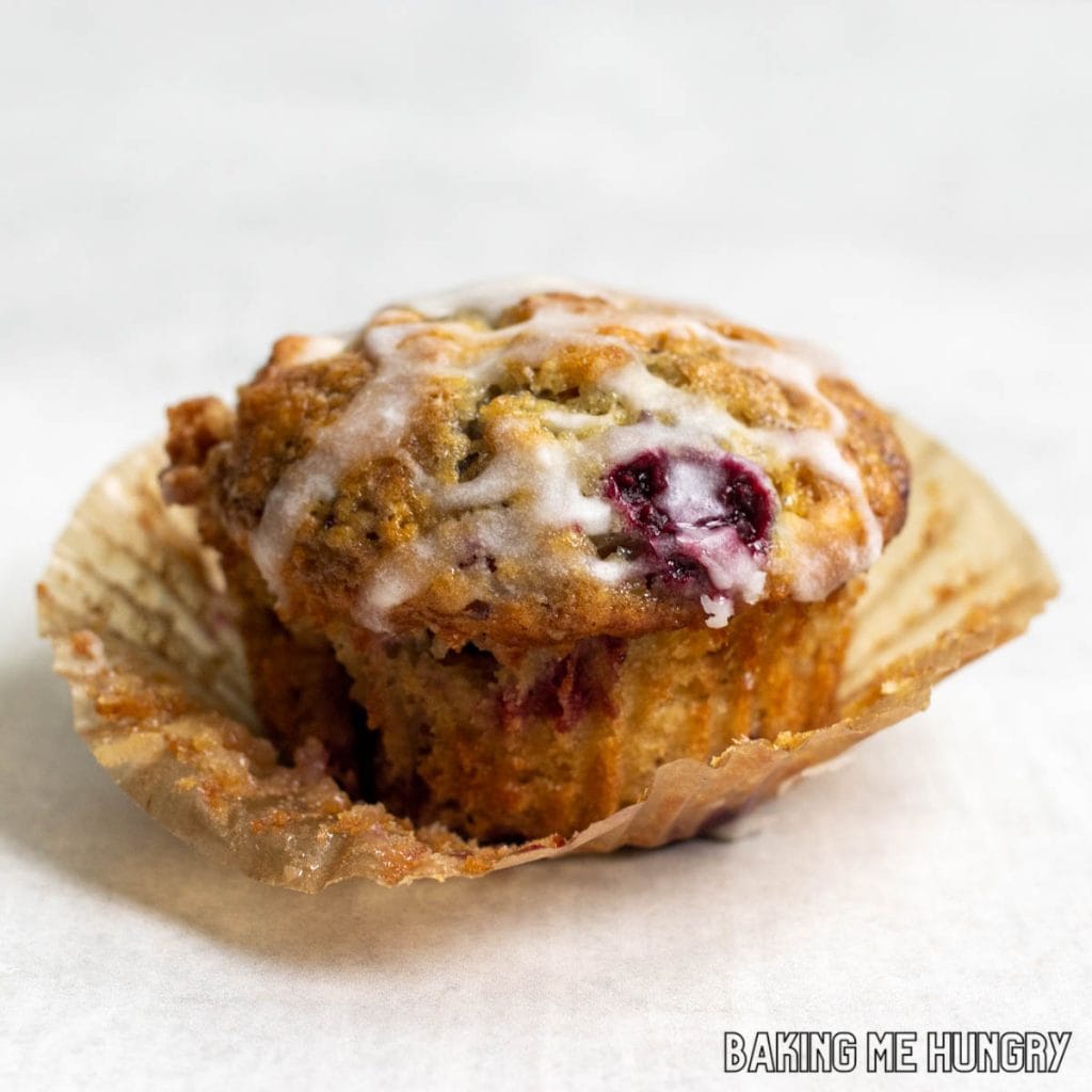 one of the raspberry white chocolate muffins recipe resting on its wrapper