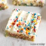 birthday cake blondies recipe cut into bars and shown close up on white surface