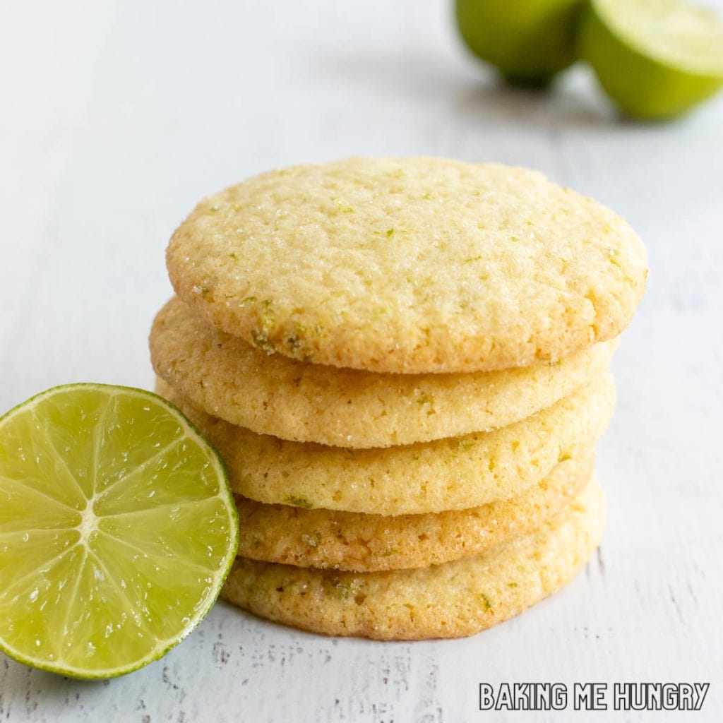 lime sugar cookies in a stack next to halved lime