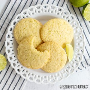 lime sugar cookies with one missing a bite on a plate close up