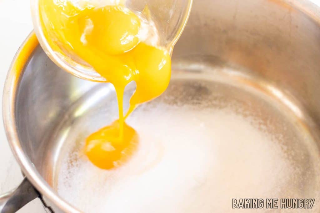 egg yolks being added