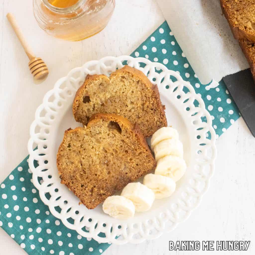 honey banana bread slices on plate close up with extra bananas