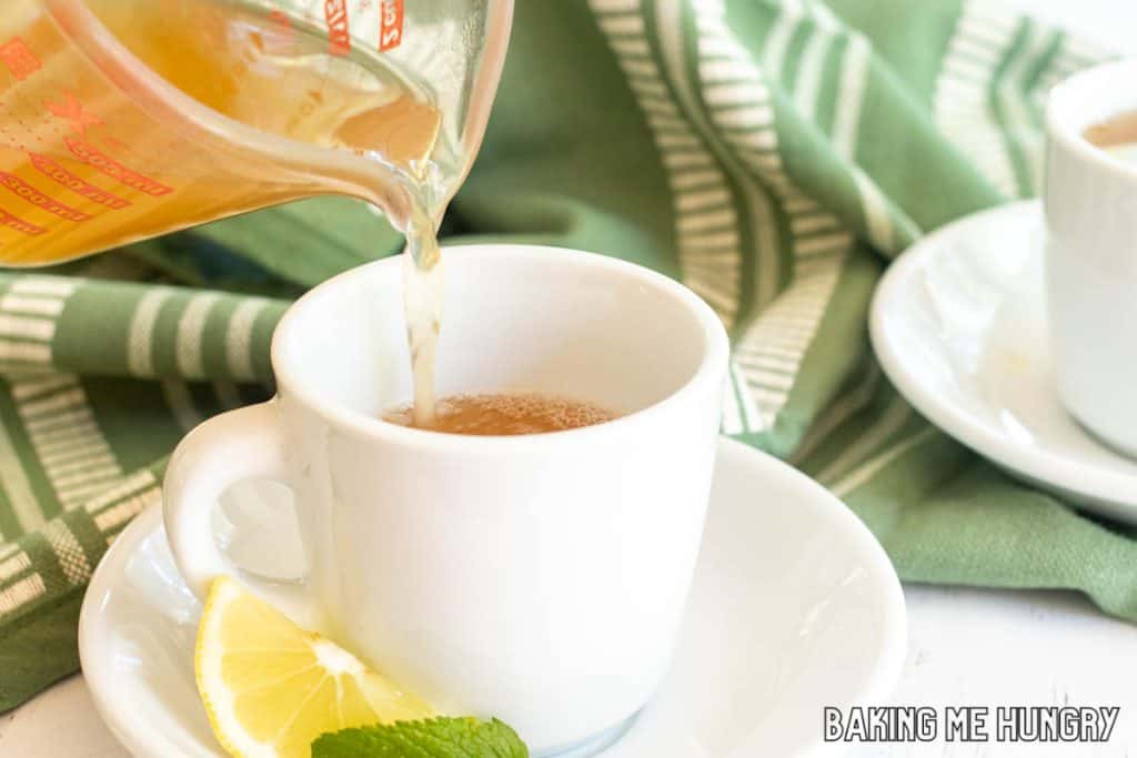 honey citrus mint tea recipe being poured into tea cup
