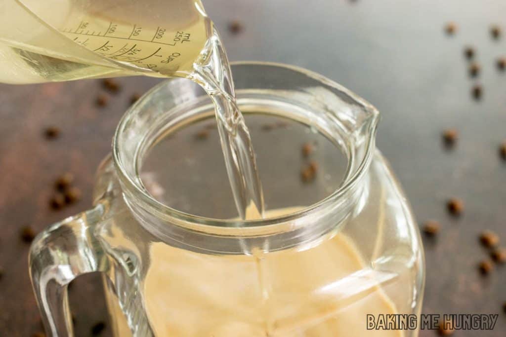 simple syrup being poured into pitcher