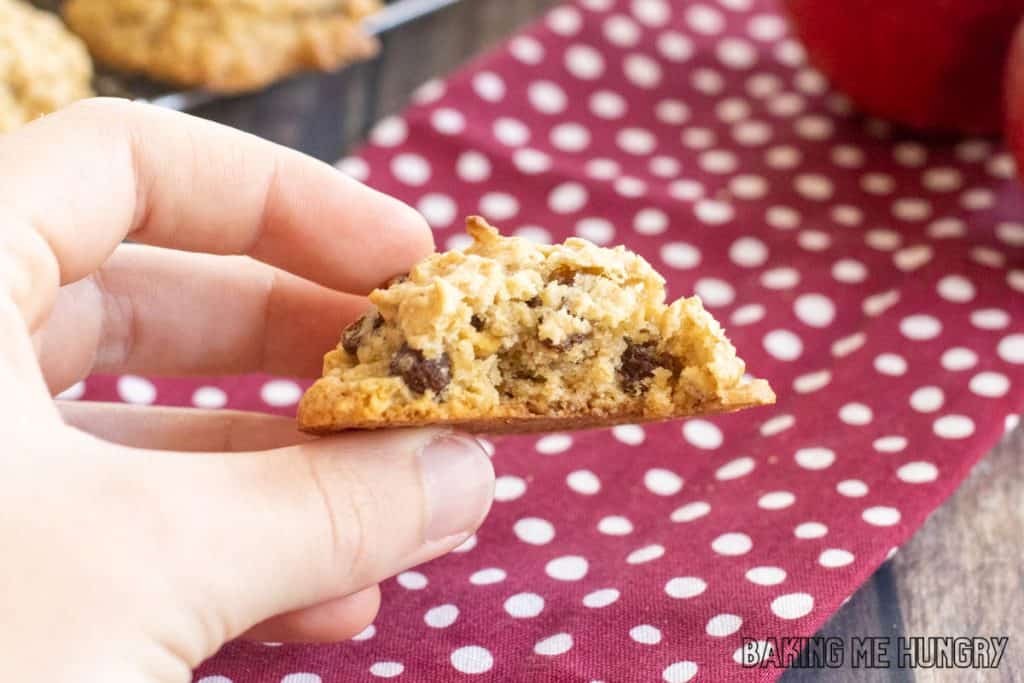 hand holding one of the apple raisin cookies missing a bite
