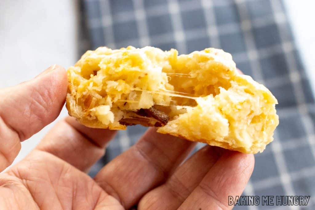 hand holding one of the cheese and bacon muffins