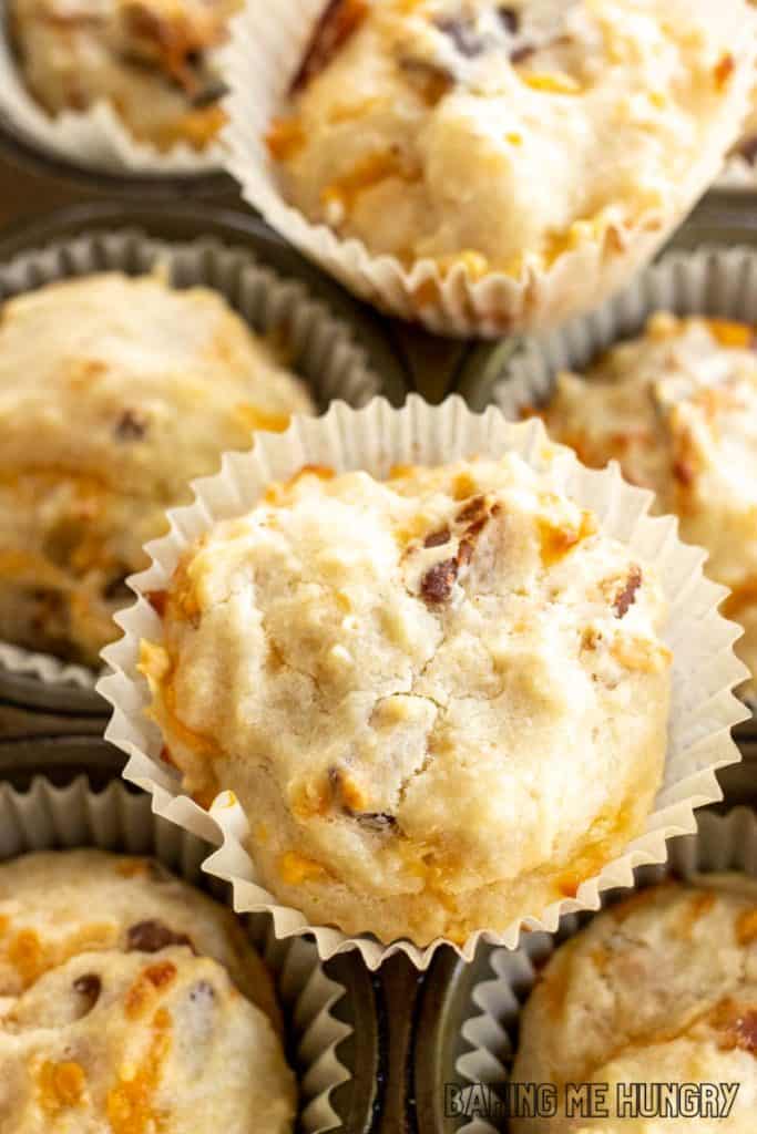 cheese and bacon muffins resting on muffin tin