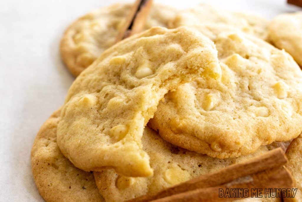 bite missing from a cinnamon white chocolate cookie in a pile