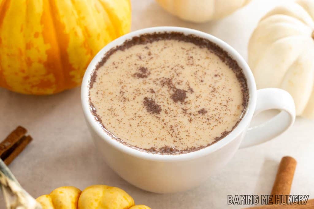 pumpkin chai latte in a mug with cinnamon on top