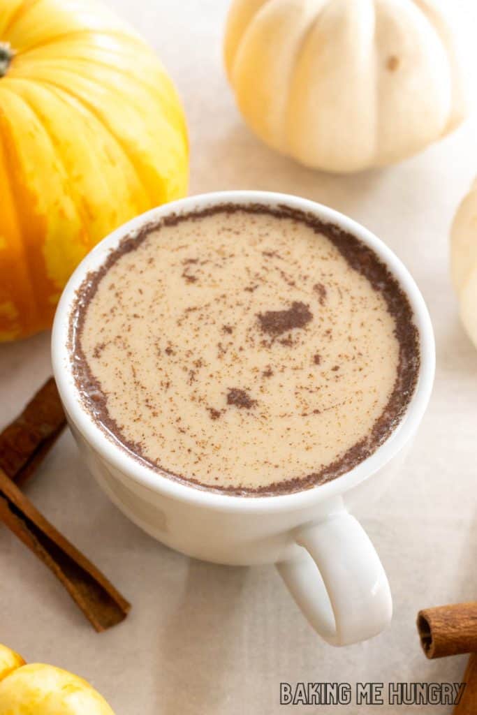 pumpkin chai latte in a mug with cinnamon on top close up