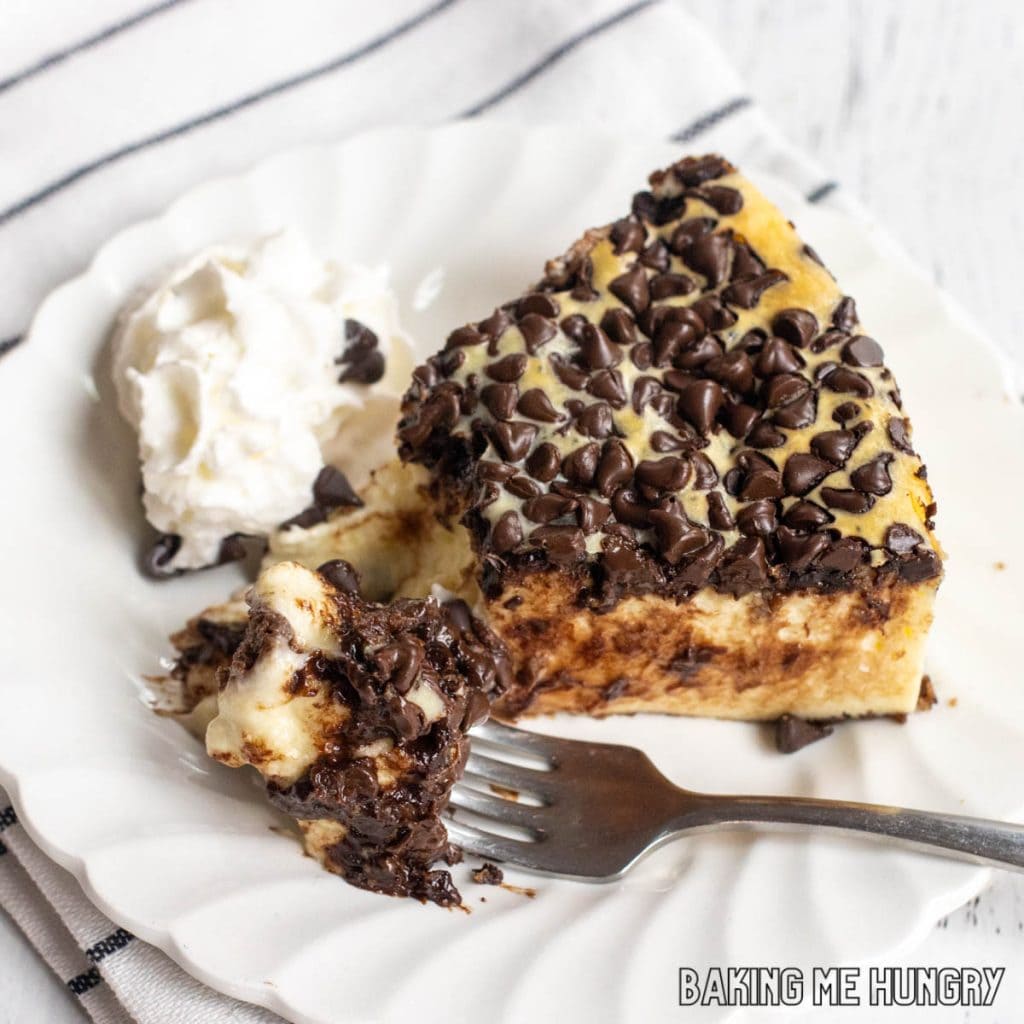 chocolate chip cheesecake recipe served on small plate with bite on a fork from overhead