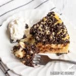 chocolate chip cheesecake recipe served on small plate with bite on a fork from overhead